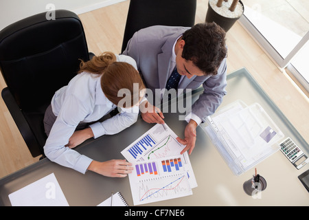 Above view of consultant analyzing data with her client Stock Photo
