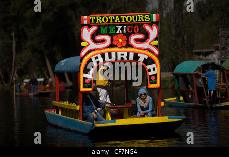 Tourists trevel in a boat through the water canals of Xochimilco on the south side of Mexico City Stock Photo