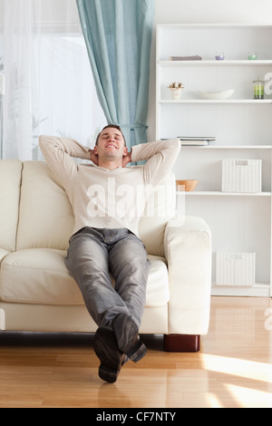 Portrait of a happy man relaxing on a couch Stock Photo