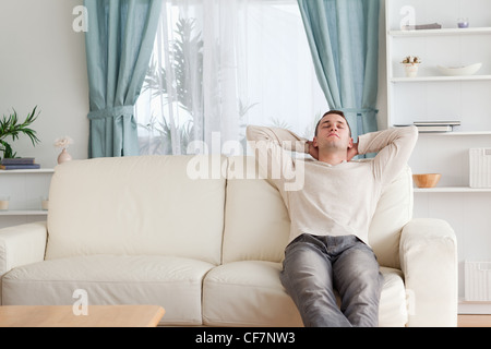 Man resting on a couch Stock Photo