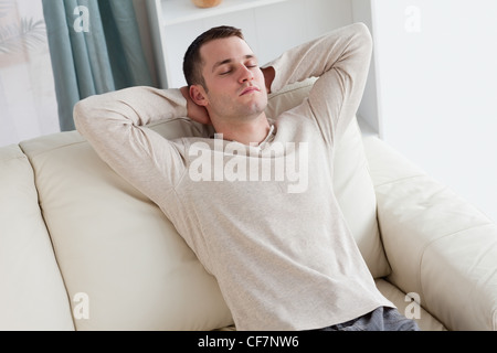 Man resting on a sofa Stock Photo