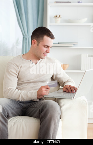 Portrait of young man in shopping centre Stock Photo - Alamy