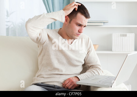 Confused man using a notebook Stock Photo