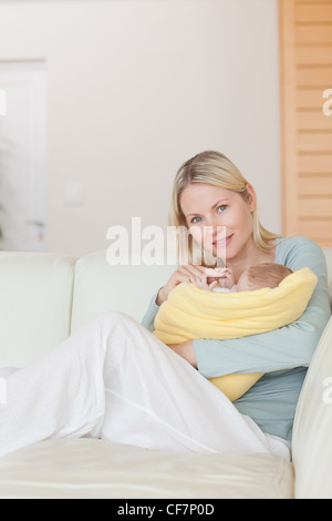Baby reaching for it's mothers finger