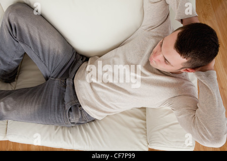 Young man lying on a sofa Stock Photo