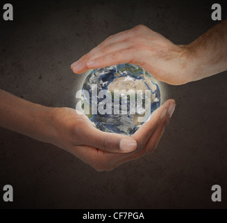 Two hands protecting a glowing planet globe Stock Photo