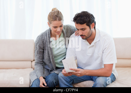 Couple opening an envelope Stock Photo