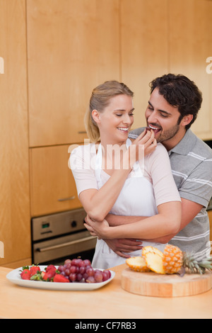 Portrait of a young couple eating fruits Stock Photo