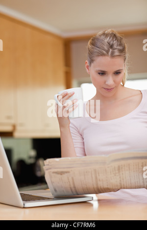 Portrait of a woman reading the news while having coffee Stock Photo
