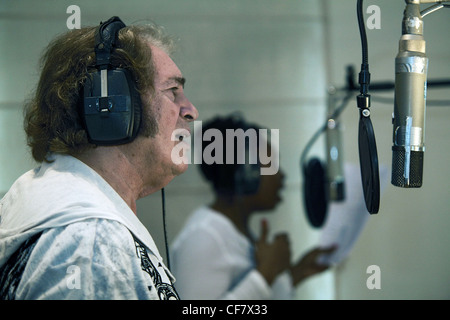 Engelbert Humperdinck UKs Eurovision entery singing in a recording studio with headphones on and singing into a microphone Stock Photo