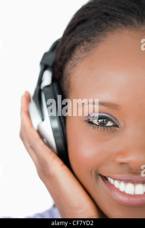 Close up of young woman with headphones on white background Stock Photo