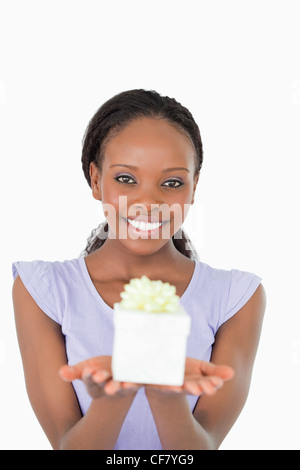Close up of smiling woman holding a present against a white background Stock Photo
