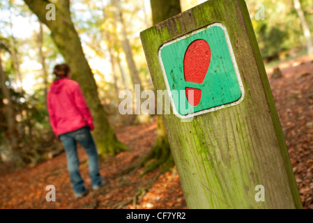 walker on a footpath with footpath sign Stock Photo