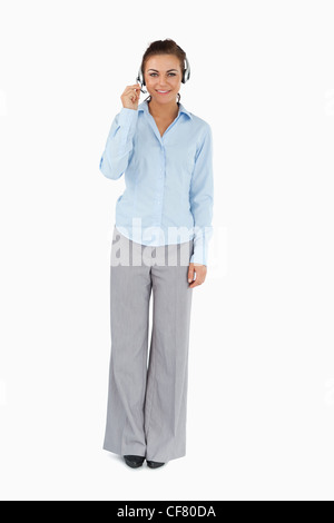 Businesswoman talking to caller through headset Stock Photo