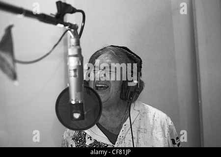 Engelbert Humperdinck UKs Eurovision entery singing in a recording studio with headphones on and singing into a microphone Stock Photo