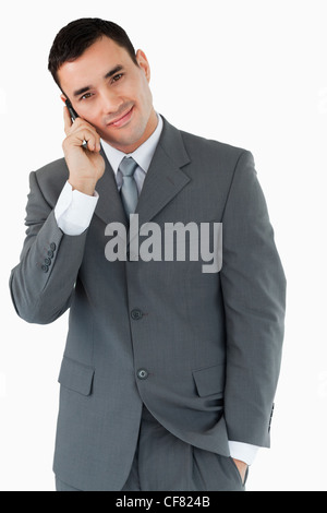 Smiling businessman ringing someone Stock Photo