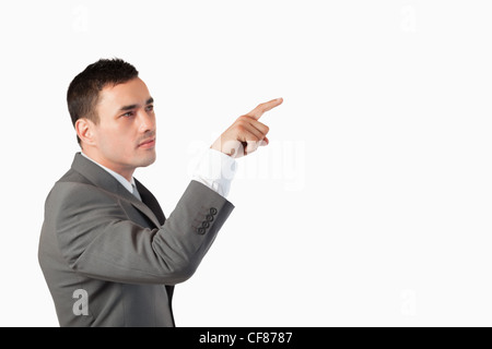 Businessman pressing an invisible key Stock Photo