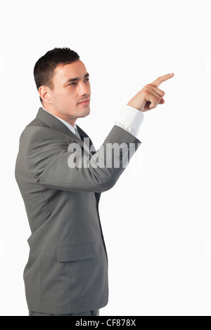 Portrait of a young businessman pressing an invisible key Stock Photo