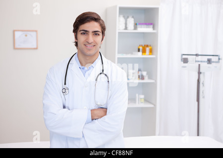 Male doctor standing with arms folded Stock Photo