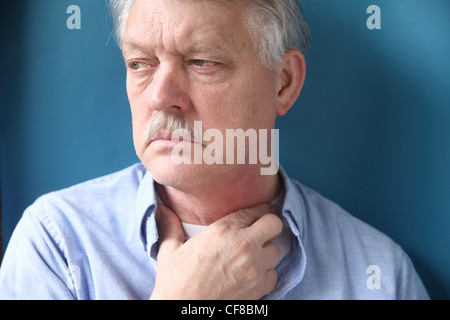 senior man with throat or neck irritation Stock Photo