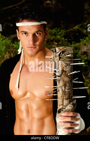 View of a fighter male holding a mace weapon on a forest. Stock Photo