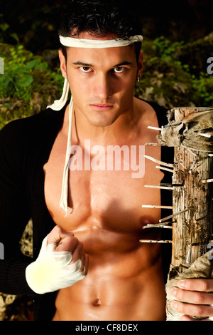 View of a fighter male holding a mace weapon on a forest. Stock Photo