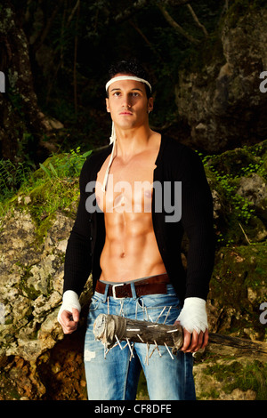 View of a fighter male holding a mace weapon on a forest. Stock Photo