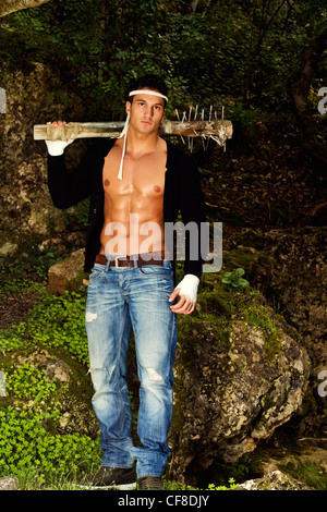 View of a fighter male holding a mace weapon on a forest. Stock Photo