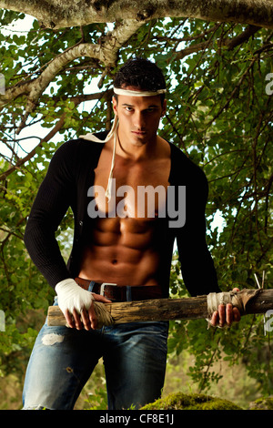 View of a fighter male holding a mace weapon on a forest. Stock Photo