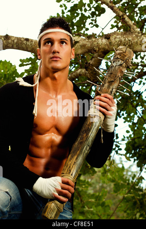 View of a fighter male holding a mace weapon on a forest. Stock Photo