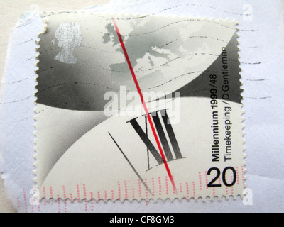 Close up of a British postage stamp with clock hand dials at midnight, ushering the New Year in. Stock Photo