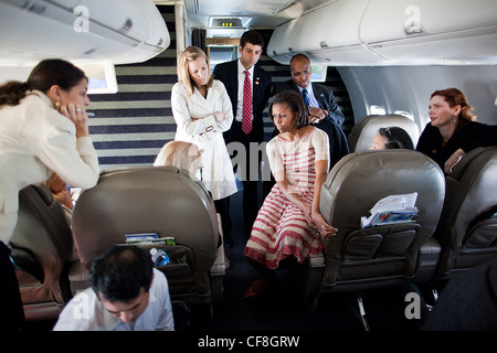 First Lady Michelle Obama and Dr. Jill Biden, seated far left, meet with staff aboard Bright Star during a flight from New River Marine Corps Air Station in North Carolina to Lackland Air Force Base in San Antonio, Texas, April 13, 2011. Stock Photo