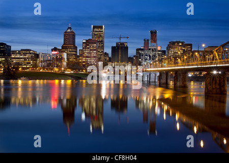 Portland Oregon Downtown City Skyline with Hawthorne Bridge along Willamette River at Blue Hour Stock Photo