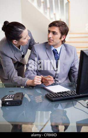Businesswoman explaining something to her colleague Stock Photo