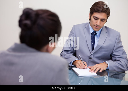 Businessman in meeting taking notes Stock Photo
