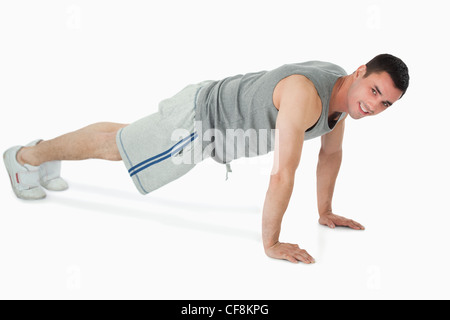 Side view of man doing push ups Stock Photo