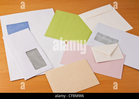 many different colored envelopes on a table Stock Photo