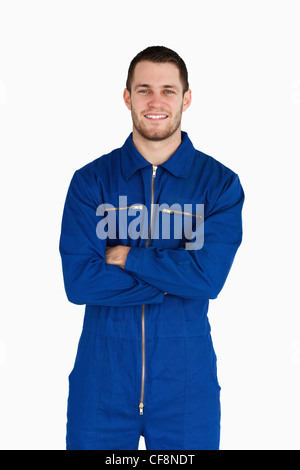 Smiling mechanic in boiler suit with folded arms Stock Photo