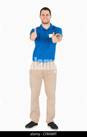 Smiling young salesman giving thumbs up Stock Photo