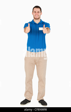 Smiling young sales assistant giving thumbs up Stock Photo