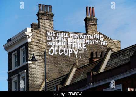 ‘ Occupy ‘ movement slogan painted on the side of a building, City of London, England Stock Photo