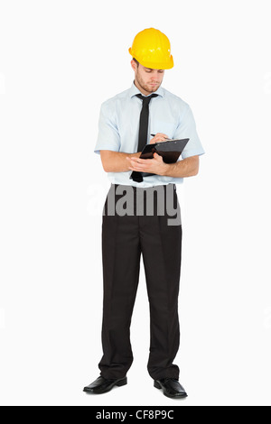 Young foreman taking notes on his clipboard Stock Photo