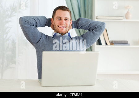 Smiling businessman leaning back Stock Photo