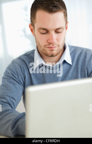 Young man typing on laptop Stock Photo