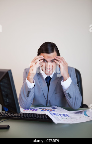 Frustrated businessman working on statistics Stock Photo