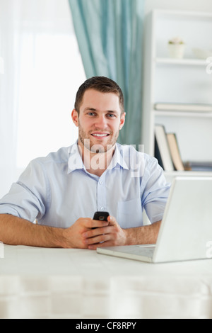 Businessman texting on his cellphone Stock Photo