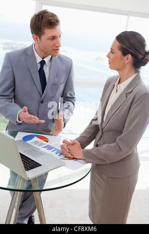 Market analysts talking about results Stock Photo