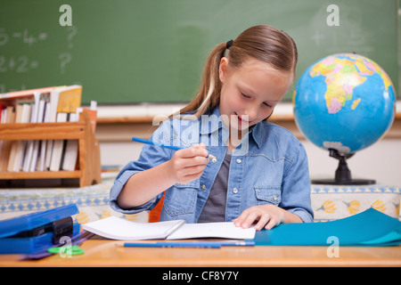 Schoolgirl doing classwork Stock Photo - Alamy