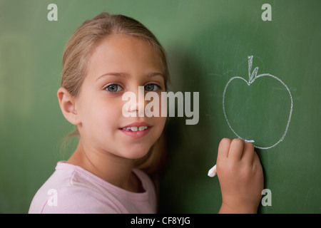 a schoolgirl with an apple and a blackboard Stock Photo - Alamy