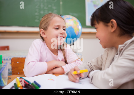 Happy schoolgirls drawing Stock Photo - Alamy